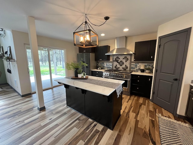 22410 S Ritchey Rd, Cheney, WA 99004 - kitchen with wall chimney range hood, stainless steel appliances, dark cabinetry, and recessed lighting