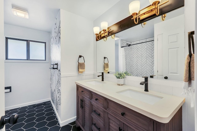 full bathroom featuring double vanity, a shower with shower curtain, a sink, and wainscoting