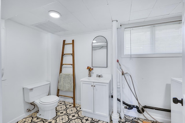 bathroom featuring visible vents, vanity, toilet, and tile patterned floors