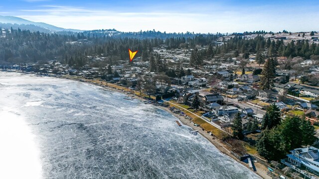 drone / aerial view featuring a water and mountain view