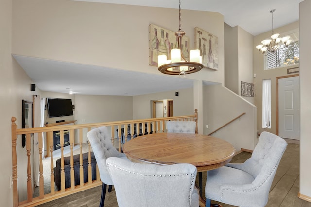 dining area featuring an inviting chandelier and high vaulted ceiling