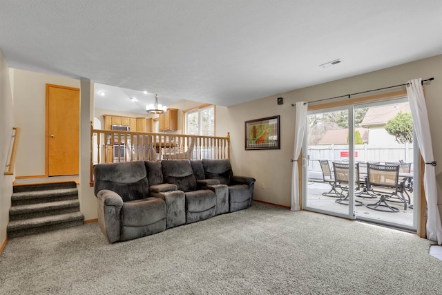 living room with carpet floors, stairway, baseboards, and visible vents