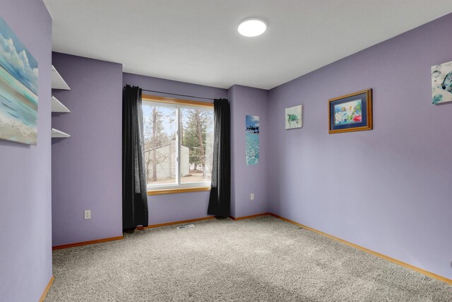 carpeted bedroom with a closet and baseboards