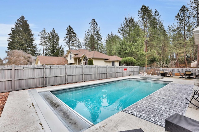 view of swimming pool with a fenced in pool, a patio area, and a fenced backyard