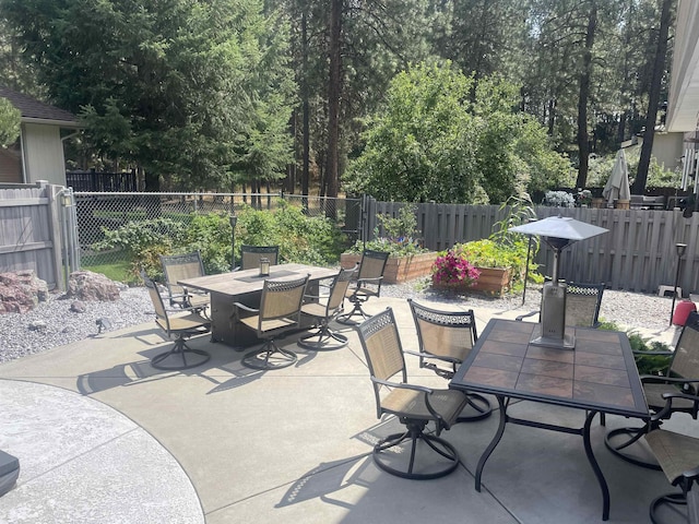 view of patio with a fenced backyard and outdoor dining space