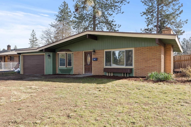 single story home featuring brick siding, a chimney, an attached garage, fence, and a front lawn