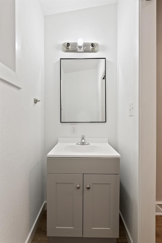 bathroom featuring vanity and baseboards