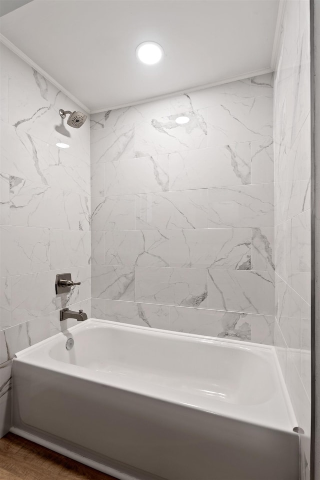 full bathroom featuring crown molding, tub / shower combination, and wood finished floors