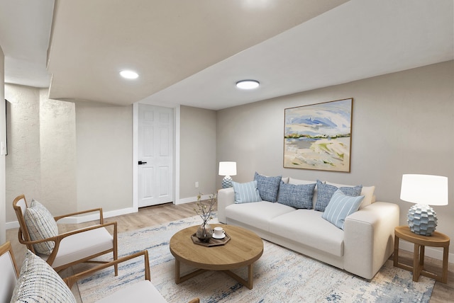 living area with light wood-style flooring and baseboards