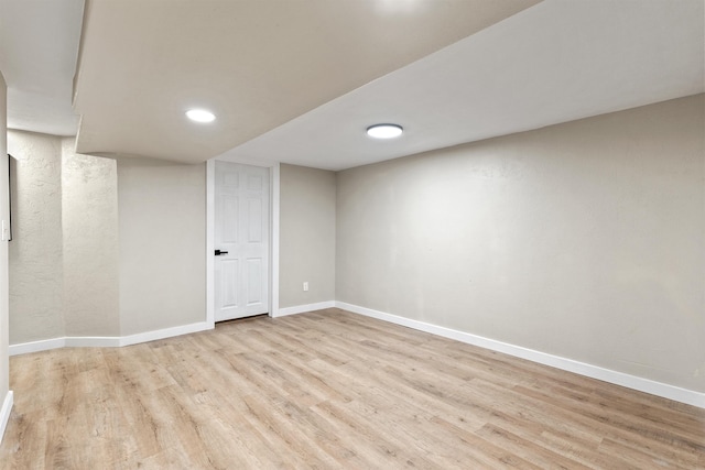 finished basement featuring baseboards and wood finished floors