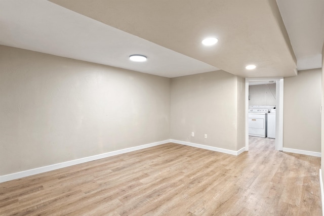 finished basement featuring light wood-style floors, washing machine and dryer, baseboards, and recessed lighting