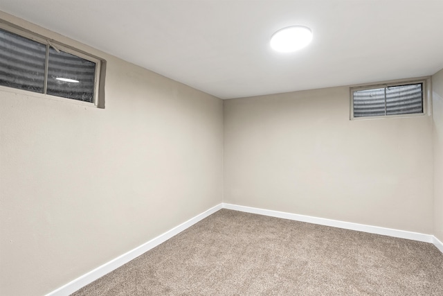 finished below grade area featuring carpet flooring and baseboards