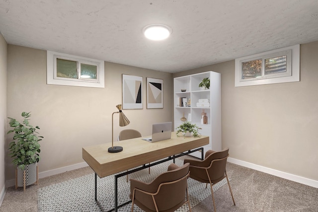 carpeted office with baseboards and a textured ceiling