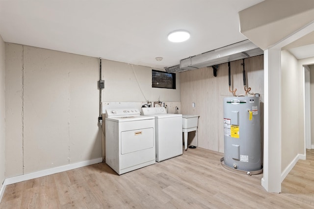 laundry room with water heater, laundry area, light wood-type flooring, and independent washer and dryer