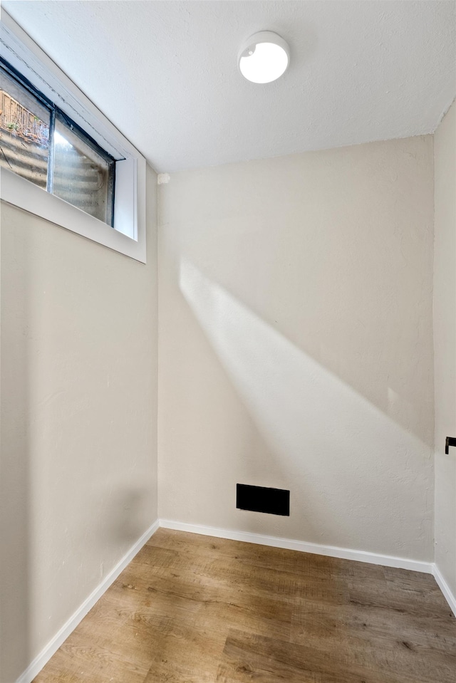 interior space with baseboards and wood finished floors