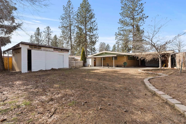 view of yard with an outbuilding and fence