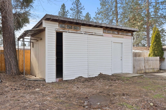 view of outbuilding with an outbuilding and fence