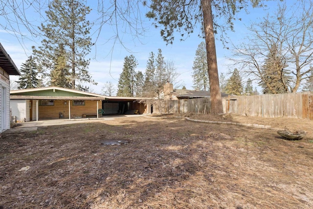 view of yard featuring a carport and fence