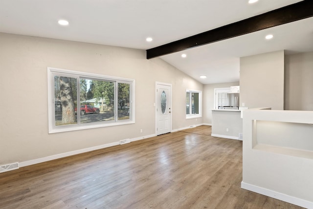 entrance foyer with light wood finished floors, baseboards, visible vents, lofted ceiling with beams, and recessed lighting