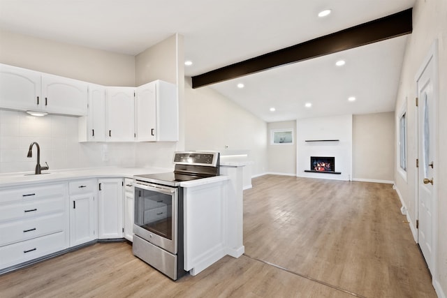 kitchen with light wood-style floors, white cabinetry, a sink, and stainless steel electric range