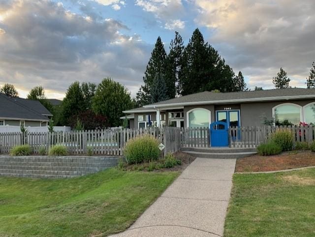 exterior space featuring a fenced front yard and a front yard