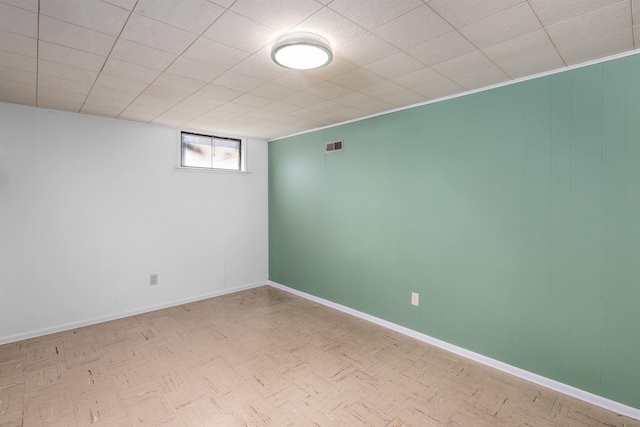 spare room featuring visible vents and baseboards