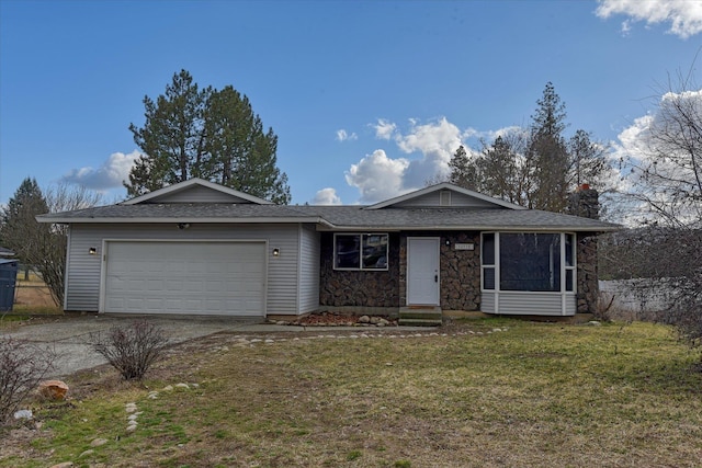 ranch-style home with driveway, stone siding, a garage, and a front yard