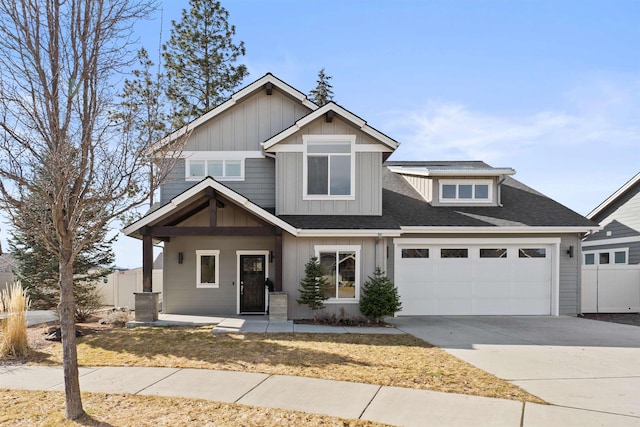 craftsman inspired home with board and batten siding, driveway, an attached garage, and fence