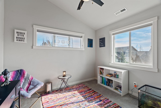 living area featuring lofted ceiling, ceiling fan, carpet floors, visible vents, and baseboards