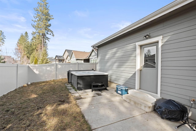 view of patio featuring a fenced backyard and a hot tub