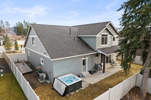 back of house with entry steps, a patio, a fenced backyard, central air condition unit, and roof with shingles