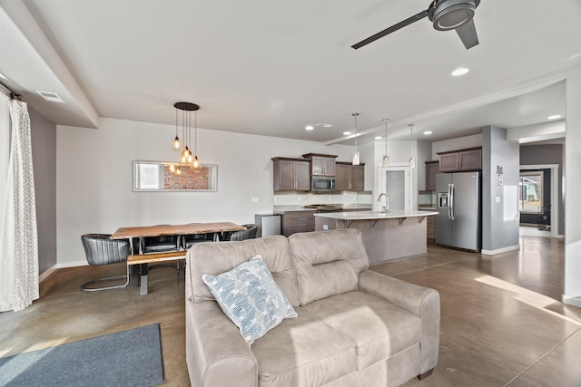 living area featuring baseboards, concrete floors, visible vents, and recessed lighting