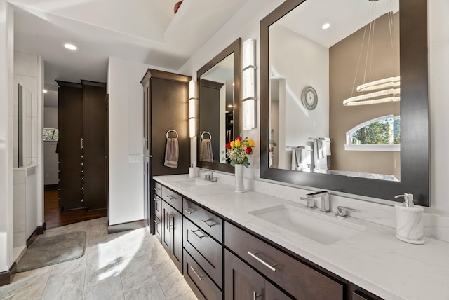 bathroom with double vanity, a sink, and recessed lighting