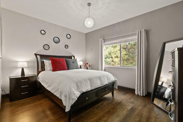 bedroom featuring dark wood finished floors and baseboards