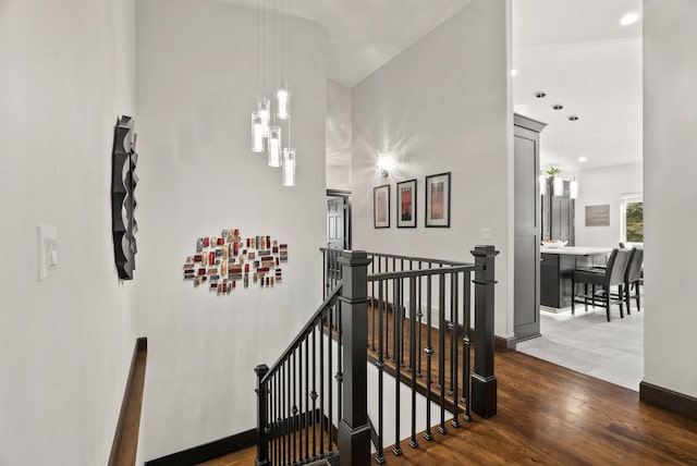 stairs featuring recessed lighting, baseboards, and wood finished floors