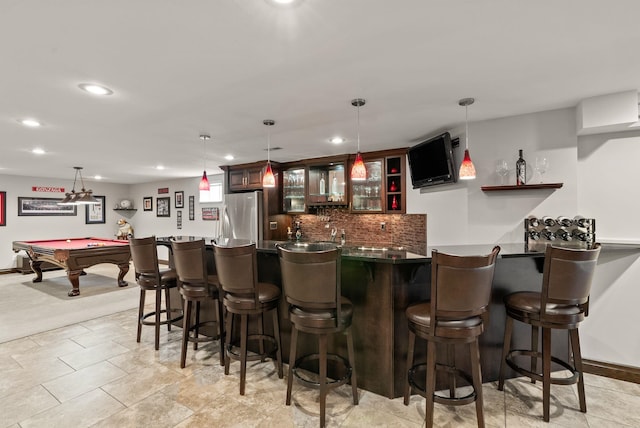 bar featuring indoor wet bar, freestanding refrigerator, hanging light fixtures, backsplash, and recessed lighting