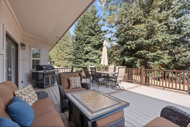 wooden deck featuring outdoor dining area, a grill, and an outdoor living space