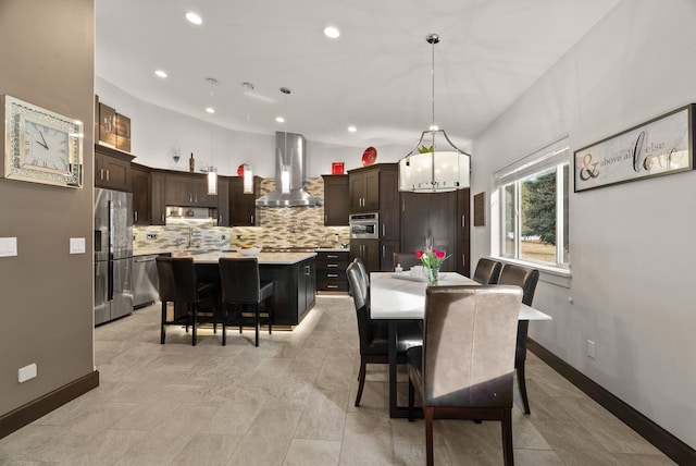 dining space featuring recessed lighting and baseboards