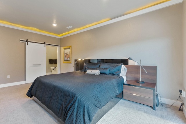 bedroom with a barn door, carpet flooring, and baseboards