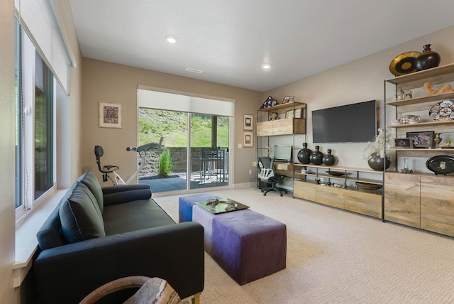 living room featuring carpet floors, baseboards, and recessed lighting