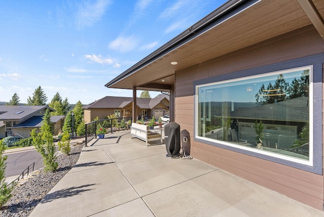 view of patio / terrace with a balcony and a residential view