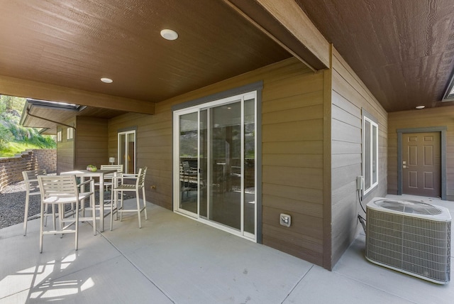 view of patio with central air condition unit and outdoor dining area