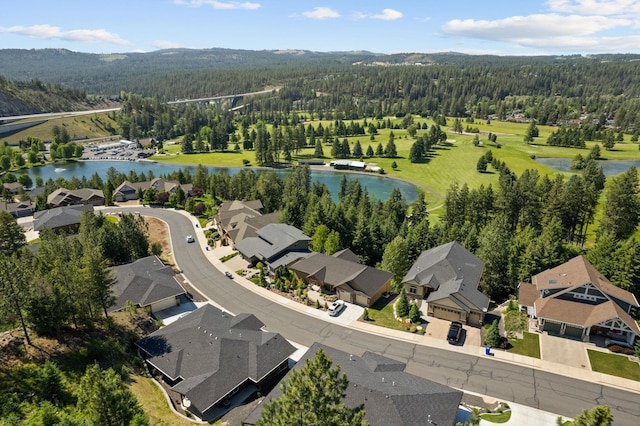 bird's eye view featuring a water view, a residential view, and a view of trees