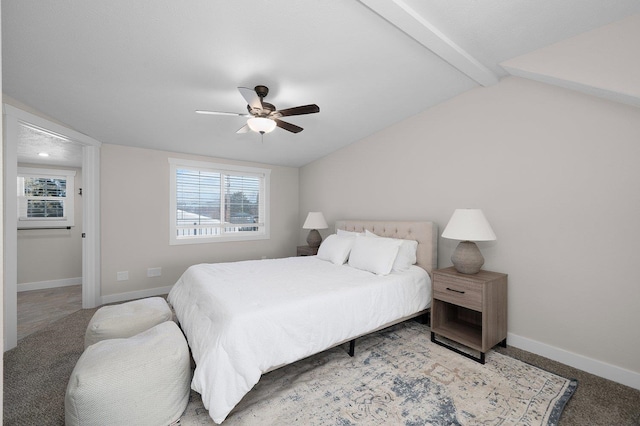 carpeted bedroom with vaulted ceiling with beams, baseboards, and ceiling fan