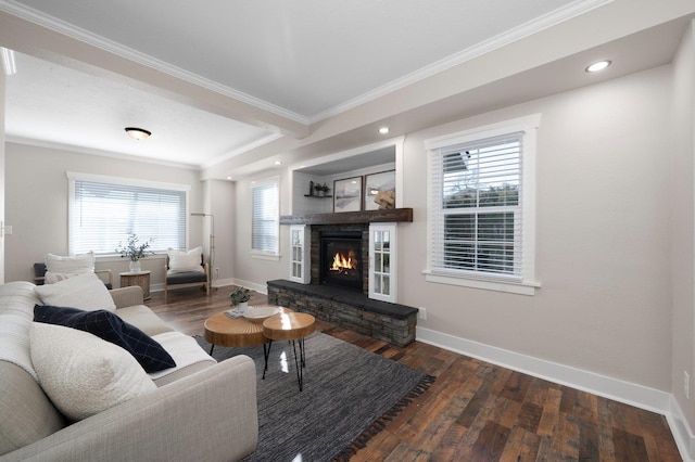 living area featuring ornamental molding, a fireplace, baseboards, and wood finished floors