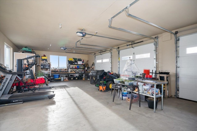 garage with a workshop area and a garage door opener