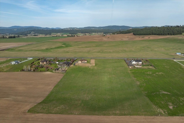 drone / aerial view with a mountain view and a rural view