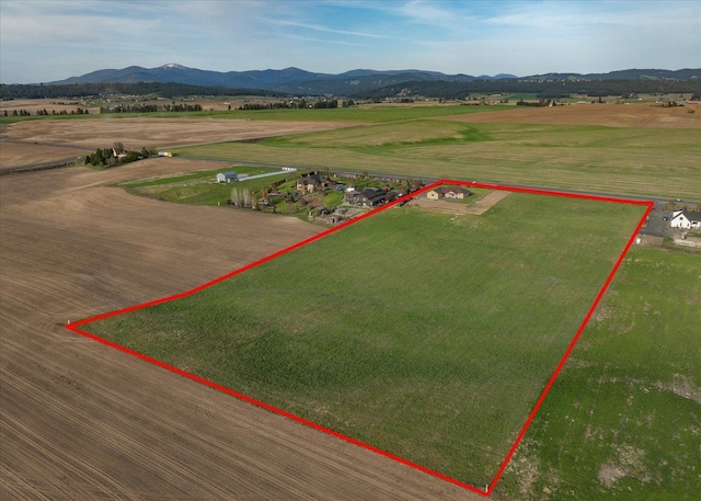 aerial view with a mountain view and a rural view