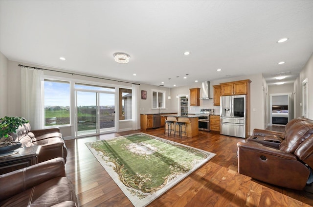 living area with dark wood finished floors and recessed lighting