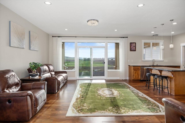 living area with recessed lighting, dark wood finished floors, and baseboards